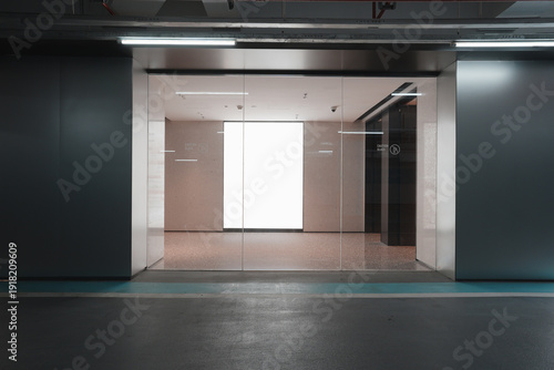 Bild auf Leinwand Underground parking garage entrance with glass doors leading to an empty modern