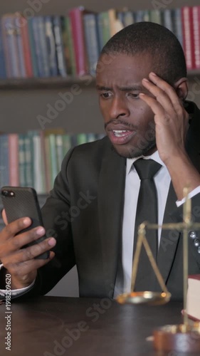 African American Lawyer Shocked by Failure News on Phone in Office, Vertical Video