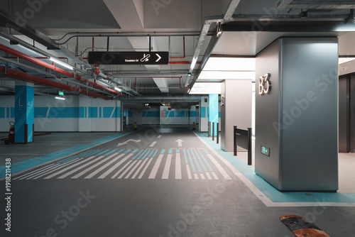 Bild auf Leinwand Empty underground parking garage level B3 with directional signage and marked la