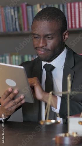 Wallpaper Mural African American Lawyer using Tablet in Office, Vertical Video Torontodigital.ca