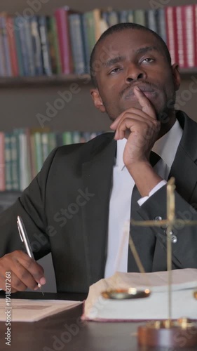 Wallpaper Mural Pensive African American Lawyer Working on Legal Documents, Vertical Video Torontodigital.ca