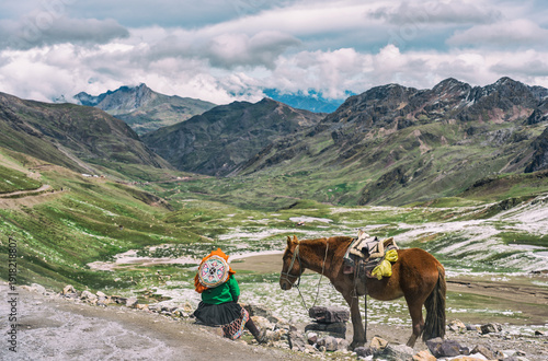 Wallpaper Mural Local peruvian woman in traditional clothes resting next to a horse with the breathtaking glacial scenery of the Vilcanota mountain range in the background Torontodigital.ca