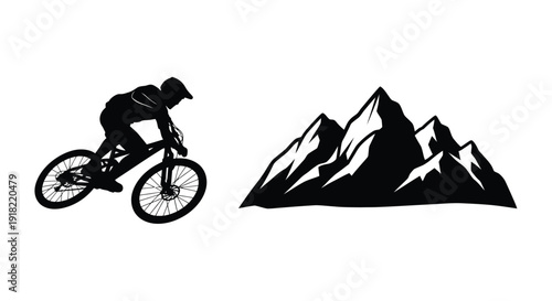 Silhouette of a mountain biker riding near a range of mountains