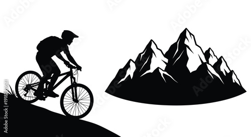 Silhouette of a mountain biker riding near sharp dark mountain peaks