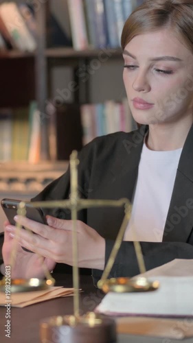 Wallpaper Mural Female Lawyer Browsing Internet on Phone in Office, Vertical Video Torontodigital.ca