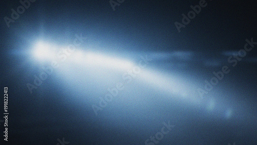 Принти на полотні Bright Light Beam Streak Across Dark Blue Hazy Sky Background