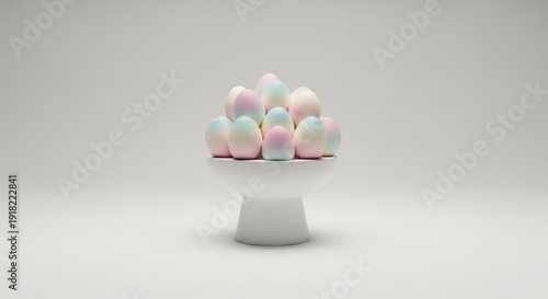 Pastel colored marshmallows are displayed artistically on a white pedestal against a light gray background.