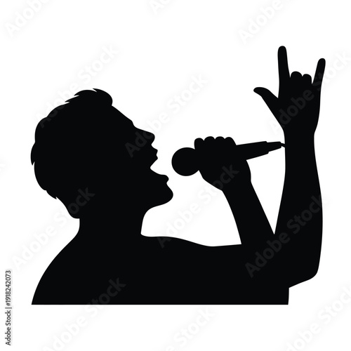 Silhouette of a singer performing with a microphone and rock gesture