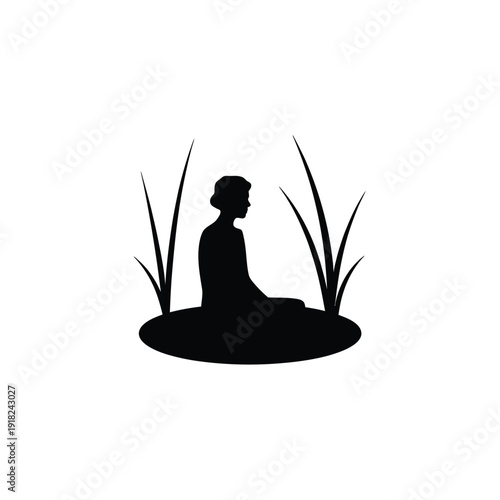 Silhouette of a person meditating amongst tall blades of grass