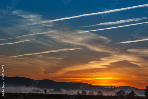 Wallpaper Mural Colorful Sunset Sky with Airplane Contrails over Misty Hills Torontodigital.ca