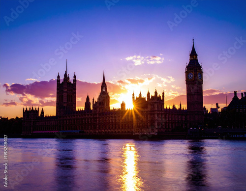 Majestic silhouette of iconic clock tower and parliament buildings at dusk. Vibrant sunburst over the Thames river creates a powerful metaphor for history, politics, and scenic travel.