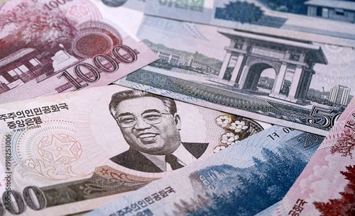 Wallpaper Mural North Korean won money bills pile on table. North Korea banknotes of KPW currency close up. Torontodigital.ca