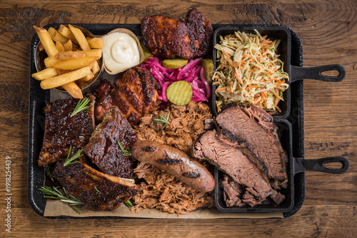 Obraz na płótnie Top view of a barbecue meat platter with ribs, pulled pork, sausage, beef briske