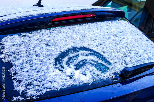 Wallpaper Mural Circular pattern cleared on a snow-covered car windshield, ready for driving Torontodigital.ca