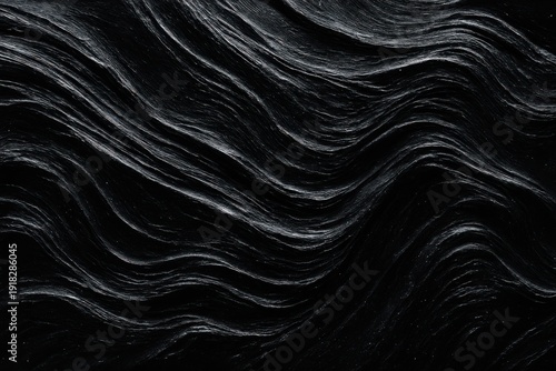 Dark rock texture with smooth undulating wave patterns and white lines