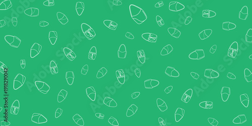 Seeds scattered across a green surface viewed from directly above