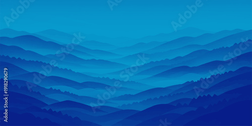 A majestic mountain peak rises above a misty valley at sunrise, where the golden horizon meets a blue sky filled with soft clouds over a vast forest landscape