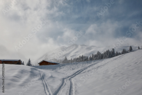 Snowy alpine cabins and ski tracks in Stoos, Switzerland