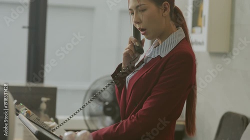 Wallpaper Mural Business concept of 4k Resolution. The receptionist is answering the phone at the hotel counter. Torontodigital.ca