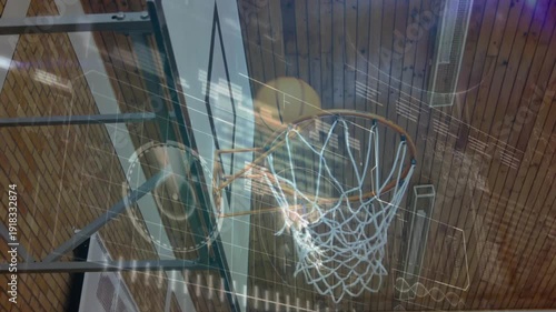 Teenager releasing basketball toward hoop in gym with analytics overlay tracking shot performance