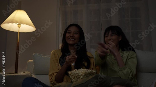 Wallpaper Mural Holiday concept of 4k Resolution. Asian women watching movies together at home. Fun and exciting leisure activities. Torontodigital.ca