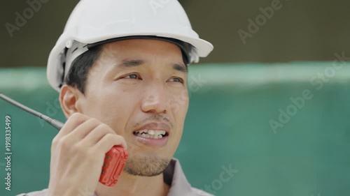 Wallpaper Mural Construction concept of 4k resolution. Asian male engineer communicating with walkie-talkie at construction site. Torontodigital.ca