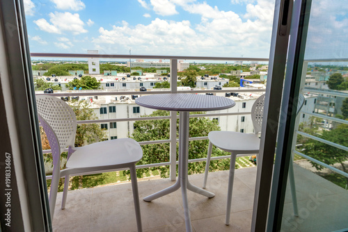 Small balcony with table and chairs city view