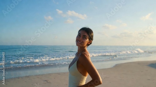 Smiling young hispanic female on sunny beach day.