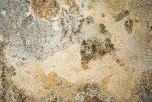 Close-up of a heavily textured and crumbling old plaster or concrete wall surface. The rough, damaged facade shows signs of decay and age, ideal for a grunge background or industrial design element.