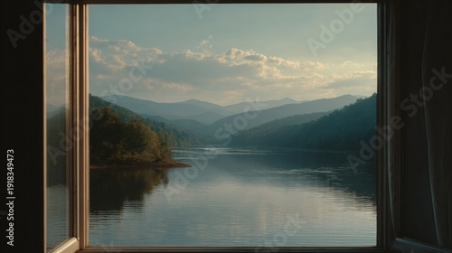 Scenic view of mountains and a lake framed by a window, evoking a sense of tranquility. The tranquil scene is viewed through an open window