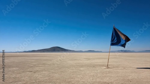 Wallpaper Mural Desert landscape with a flag waving in the wind. A barren, cracked land under a clear blue sky Torontodigital.ca
