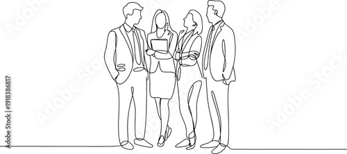 Four people in business attire standing and discussing while holding a laptop and documents