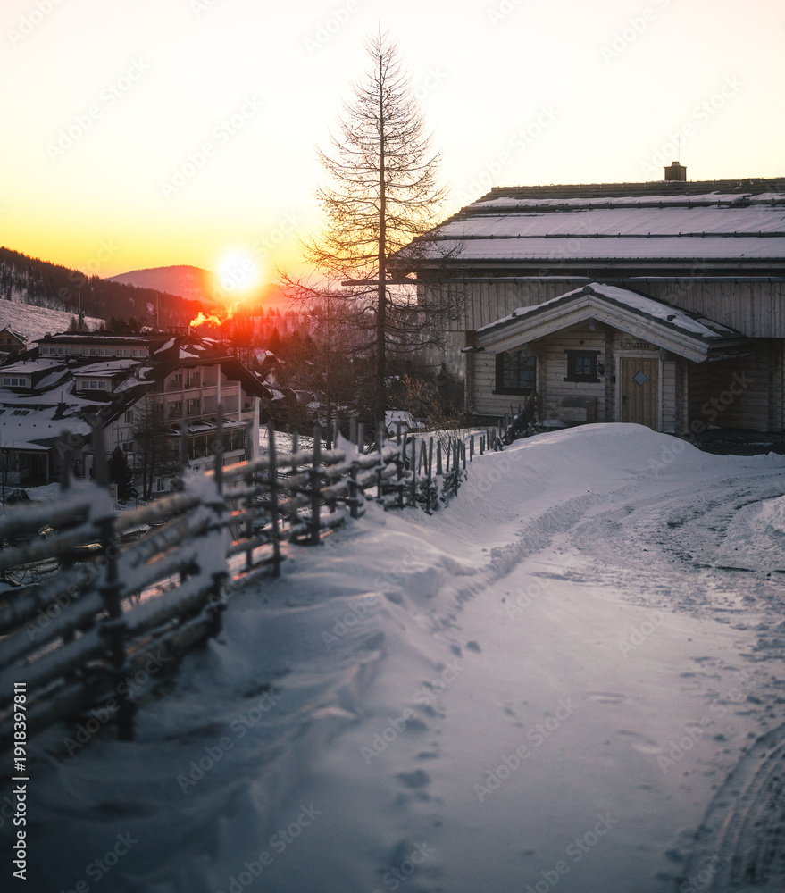 Fototapeta premium Winter Sunrise over Snow Covered Alpine Village in Falkert, Austria