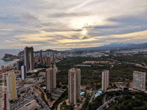 Photography dusk over oceanfront with towers and sky, golden sunset blending into sea with c