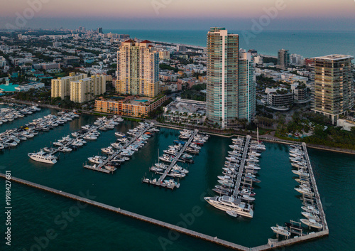 Miami Beach marina with yachts and sailboats. Miami marina and turquoise ocean. Miami seascape aerial view on south beach shore. Luxury cruise ship in Miami harbor. Skyline view of Miamis cityscapes.