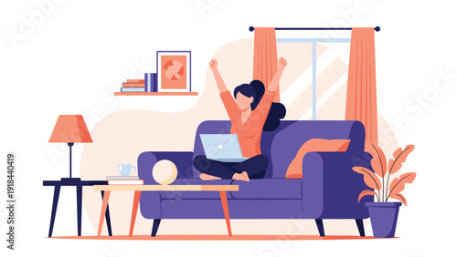 Happy woman relaxing comfortably on her sofa at home, successfully working on her laptop with arms raised in celebration.