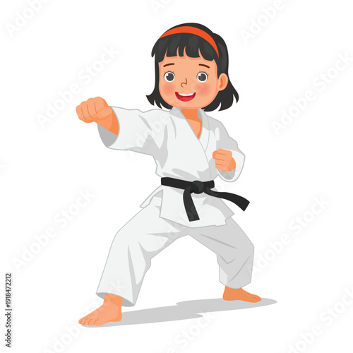 Little karate kid boy showing punch attack technique in martial art training
