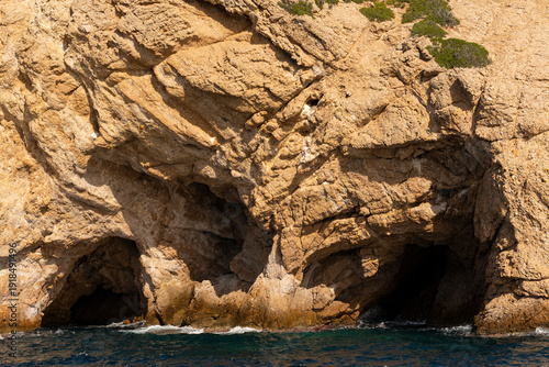 The coastline of Thassos Island. The marine landscape in Greece. Rocks, sea, trees, sky.