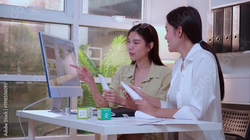 Wallpaper Mural Two asian woman designer using AI artificial intelligence assistant for cosmetic packaging design development, team business marketing planning creative, product design project with AI for idea. Torontodigital.ca