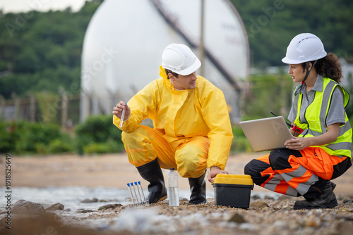 Industrial safety inspectors conducting environmental research, Technical team performing ecological impact assessment and water quality analysis at a coastal industrial zone with gas tanks