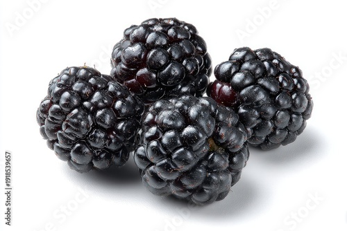 Four dark, juicy, ripe berries on a white background