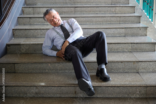 Fotografía Senior man falling down the stairs, in pain and distress