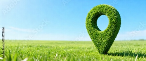 Green Location Pin on Field against Blue Sky