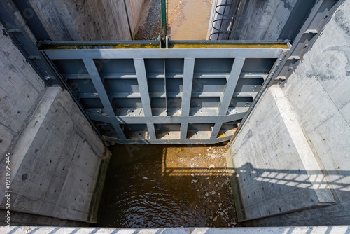 Wallpaper Mural Steel gate blocks water flow in concrete canal structure. Torontodigital.ca