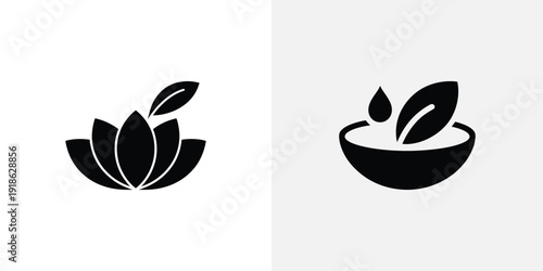 A black bowl with leaves and a drop