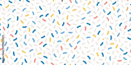 Colorful scattered sprinkles create a playful and vibrant background pattern