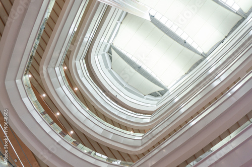 Photos Interior of a modern office building with multiple floors and a central atrium