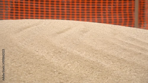 Hypnotic Cinematic Wind Skimming Over Construction Sand Pile Creating Serpentine Saltation