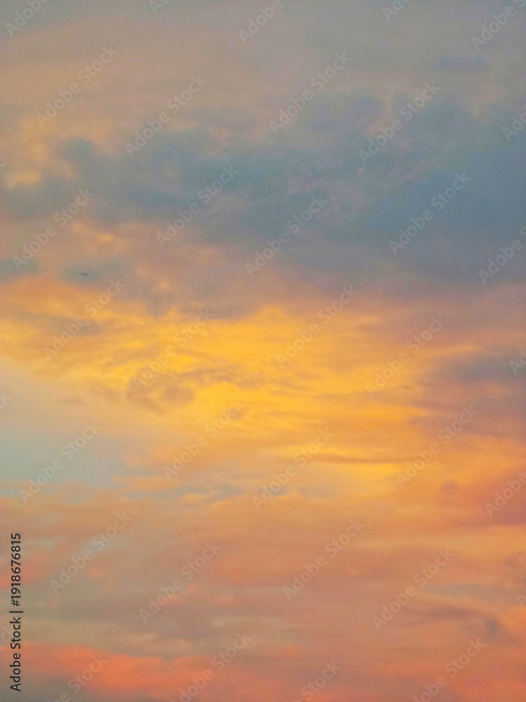Obraz premium sunset in the sky. Colorful cloudscape during twilight, showcasing vibrant hues of orange, pink and blue across a serene sky.