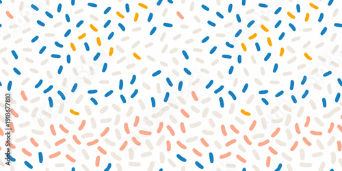 Abstract pattern of scattered colorful capsule shaped marks on white